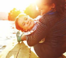 Mother and child smiling at sunset